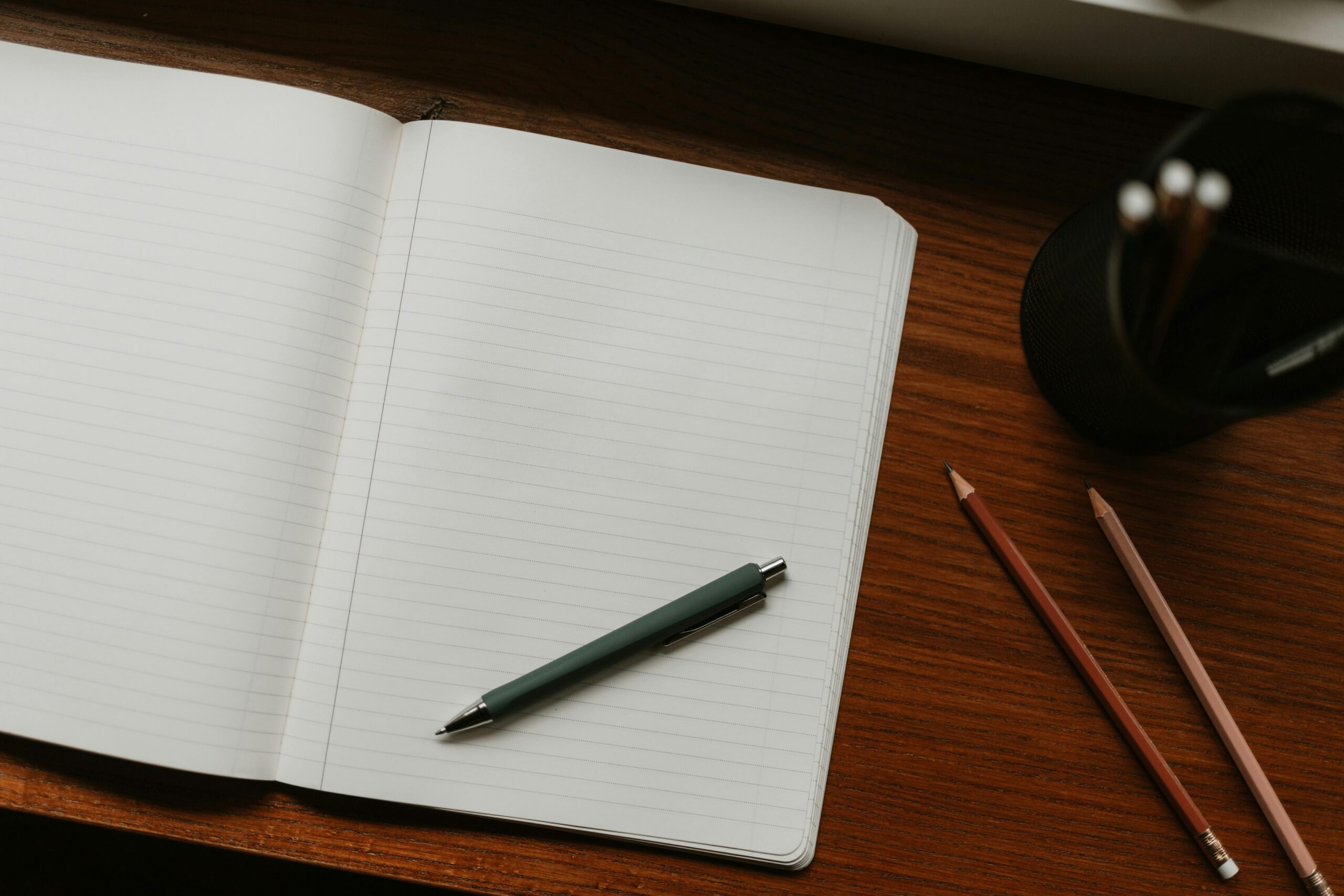 Keeper Tax review hero: freelancer reviewing tax paperwork on a desk with notebook and laptop